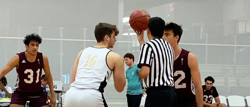 two basketball players waiting to do a jump ball
