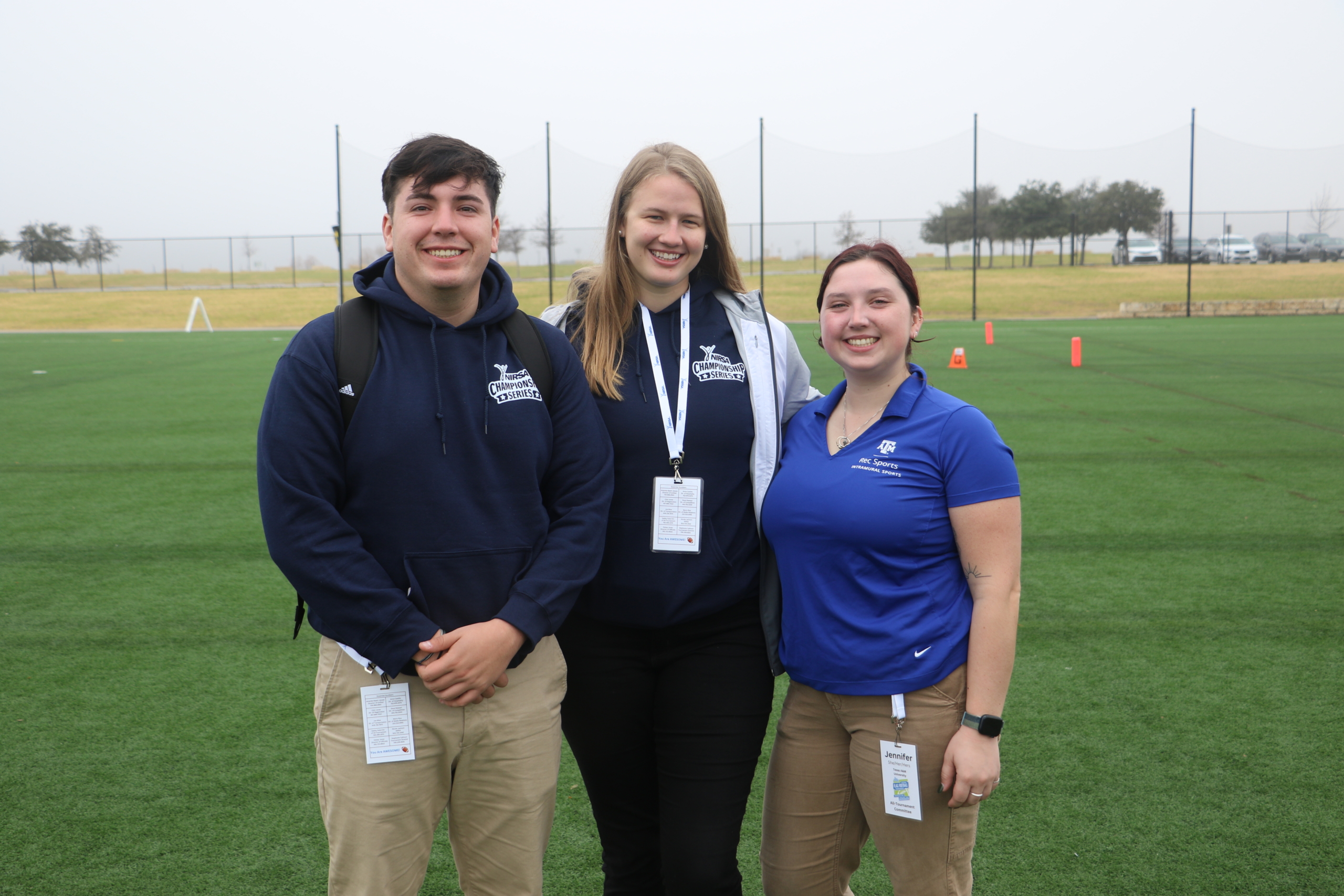 Group photo of three staff on a field